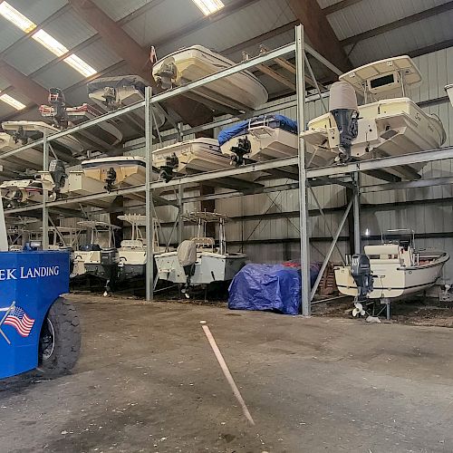 The image shows a boat storage facility with multiple boats on racks and a forklift labeled "Parish Creek Landing" in the foreground.